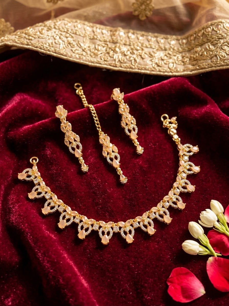Bridal jewellery set displayed on white fabric with necklace, earrings and maang tikka